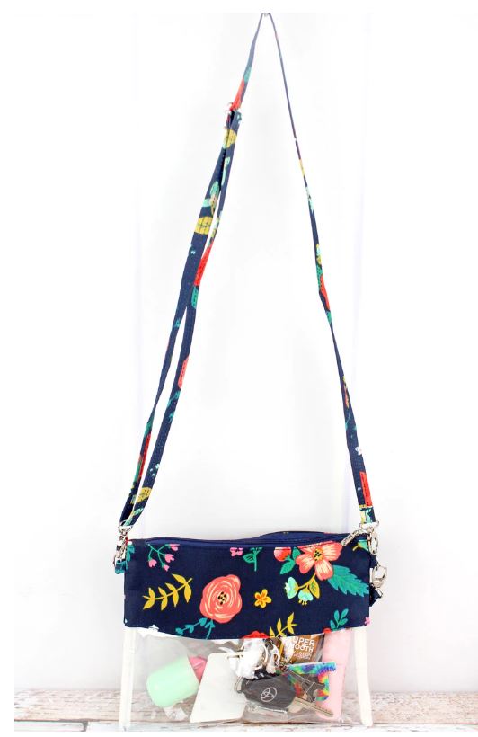 Stay organized and stylish with this clear bag that can be used as a crossbody, wristlet, or clutch. Perfect for school, work, travel, shopping, and stadiums where clear bags are required. Constructed with soft canvas and heavy-duty clear plastic, this bag features a zip top closure, detachable wristlet strap, and adjustable shoulder strap with a max. 24" drop. Measuring 7.5" wide x 9.5" tall, it keeps your necessities visible and within easy reach while on the go!